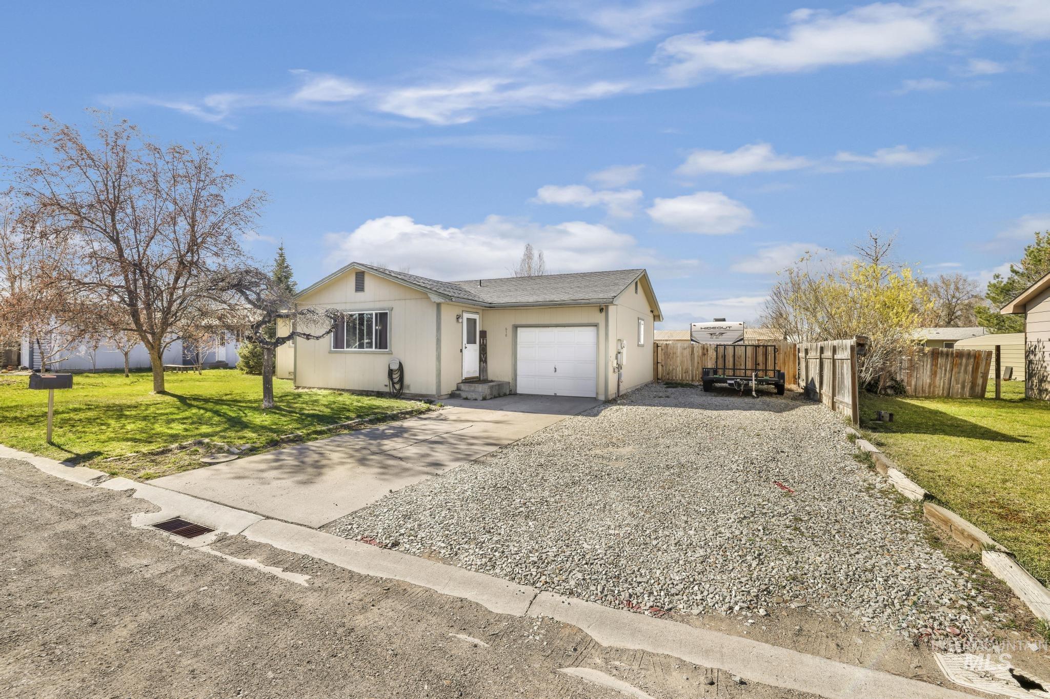 Ranch-style home featuring concrete driveway, a garage, and a shingled roof