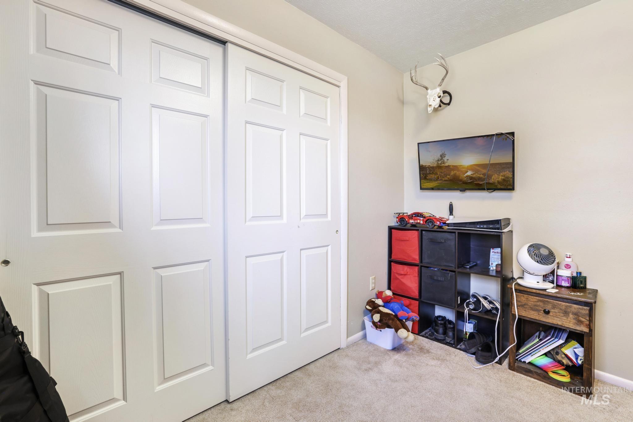 618 Sharon Street Rupert, ID 83350 - Photo 16 of 20 Rec room featuring light colored carpet and baseboards