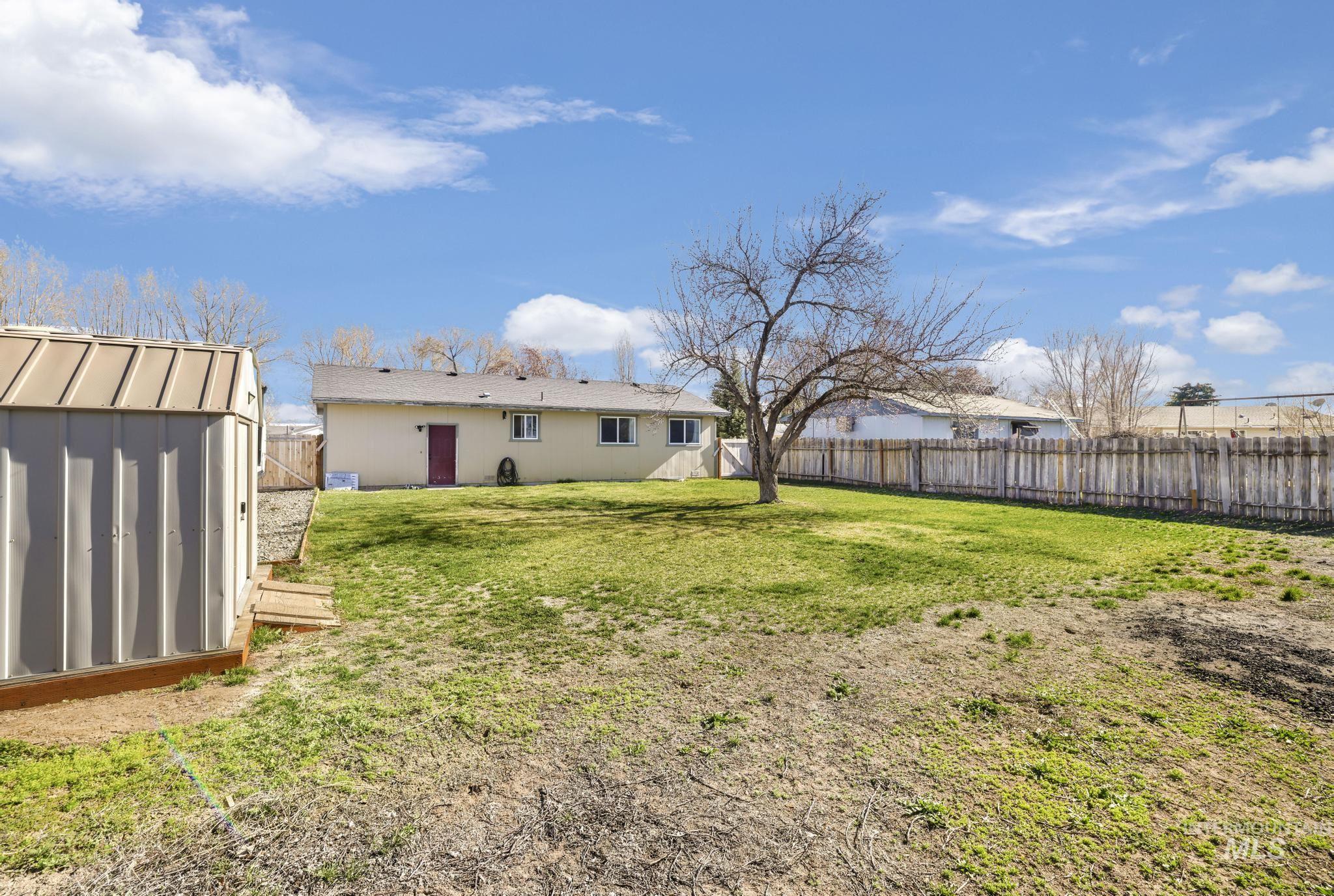 618 Sharon Street Rupert, ID 83350 - Photo 18 of 20 Rear view of property featuring a storage shed and a fenced backyard