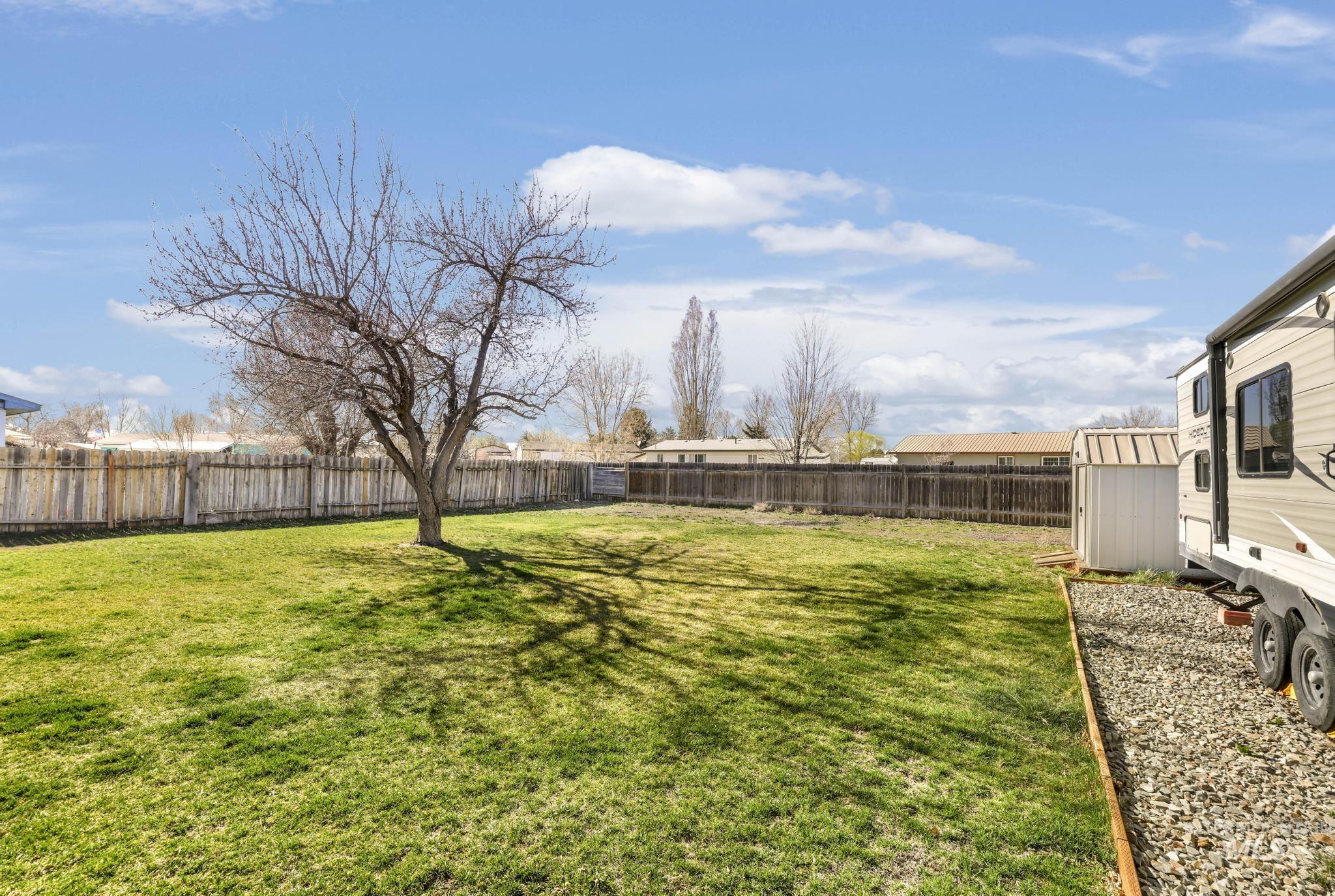 618 Sharon Street Rupert, ID 83350 - Photo 20 of 20 Fenced backyard with a storage unit