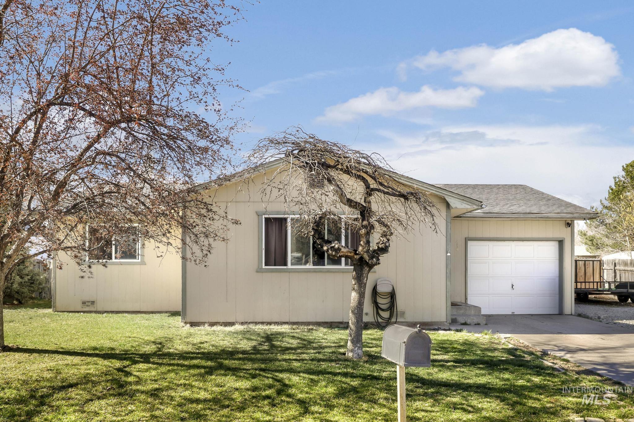 618 Sharon Street Rupert, ID 83350 - Photo 2 of 20 Ranch-style home featuring a garage, a front lawn, driveway, and roof with shingles