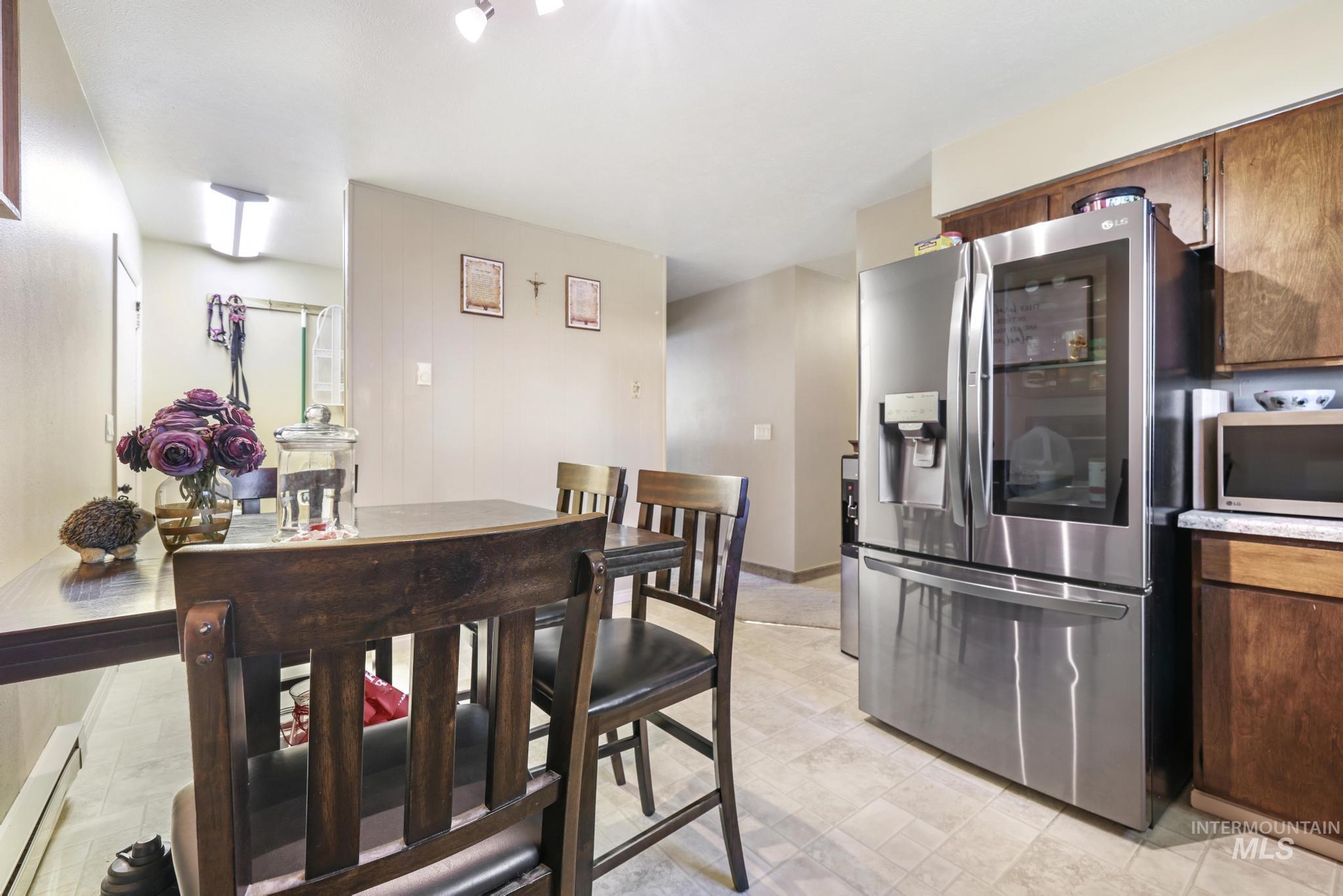 618 Sharon Street Rupert, ID 83350 - Photo 9 of 20 Kitchen with stainless steel appliances, a baseboard heating unit, light countertops, and dark wood finish cabinetry