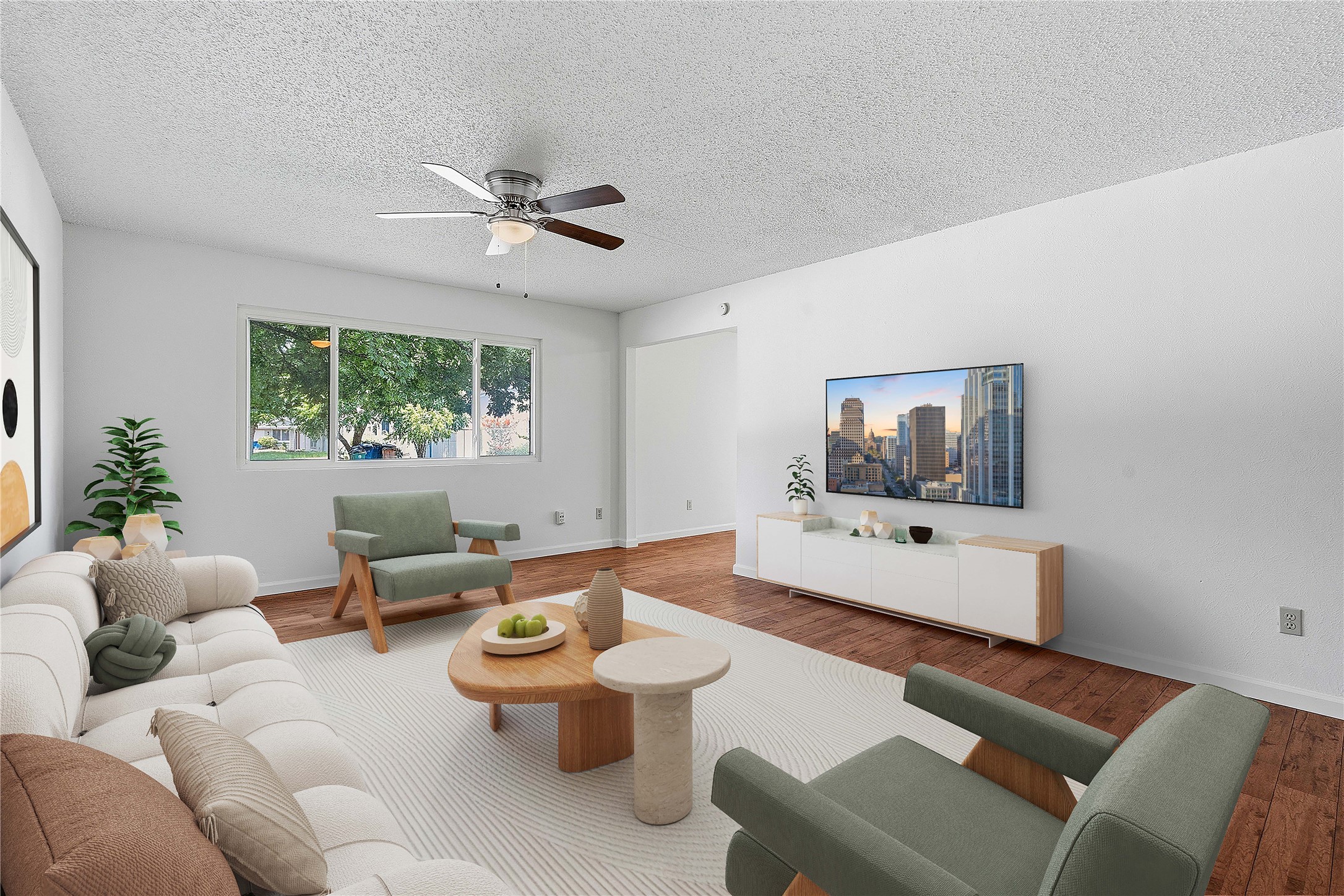 Hardwood floors and generous natural light create an inviting atmosphere in this living area.