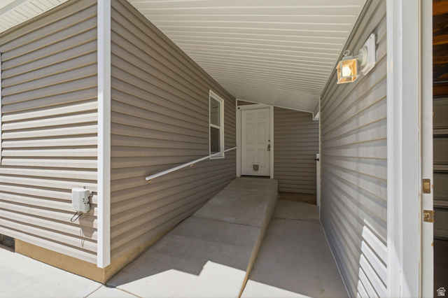 1925 South Main Street Bountiful, UT 84010 - Photo 28 of 48 Covered entryway featuring tan horizontal siding and a white paneled door