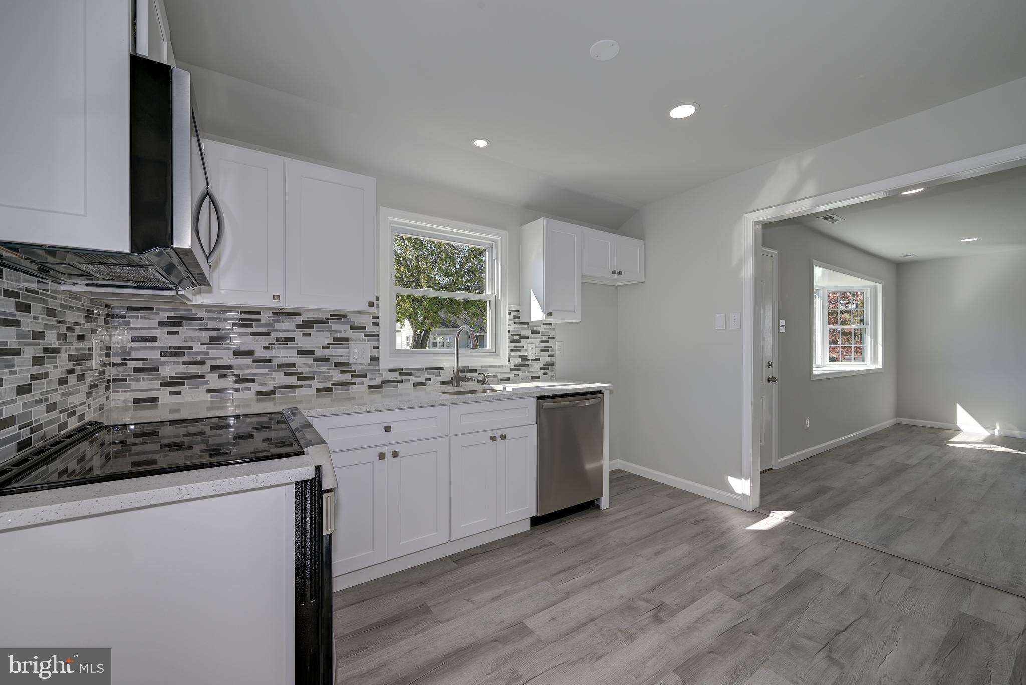 477 Buttonwood Avenue Maple Shade, NJ 08052 - Photo 15 of 32 a kitchen with granite countertop a sink and a stove top oven