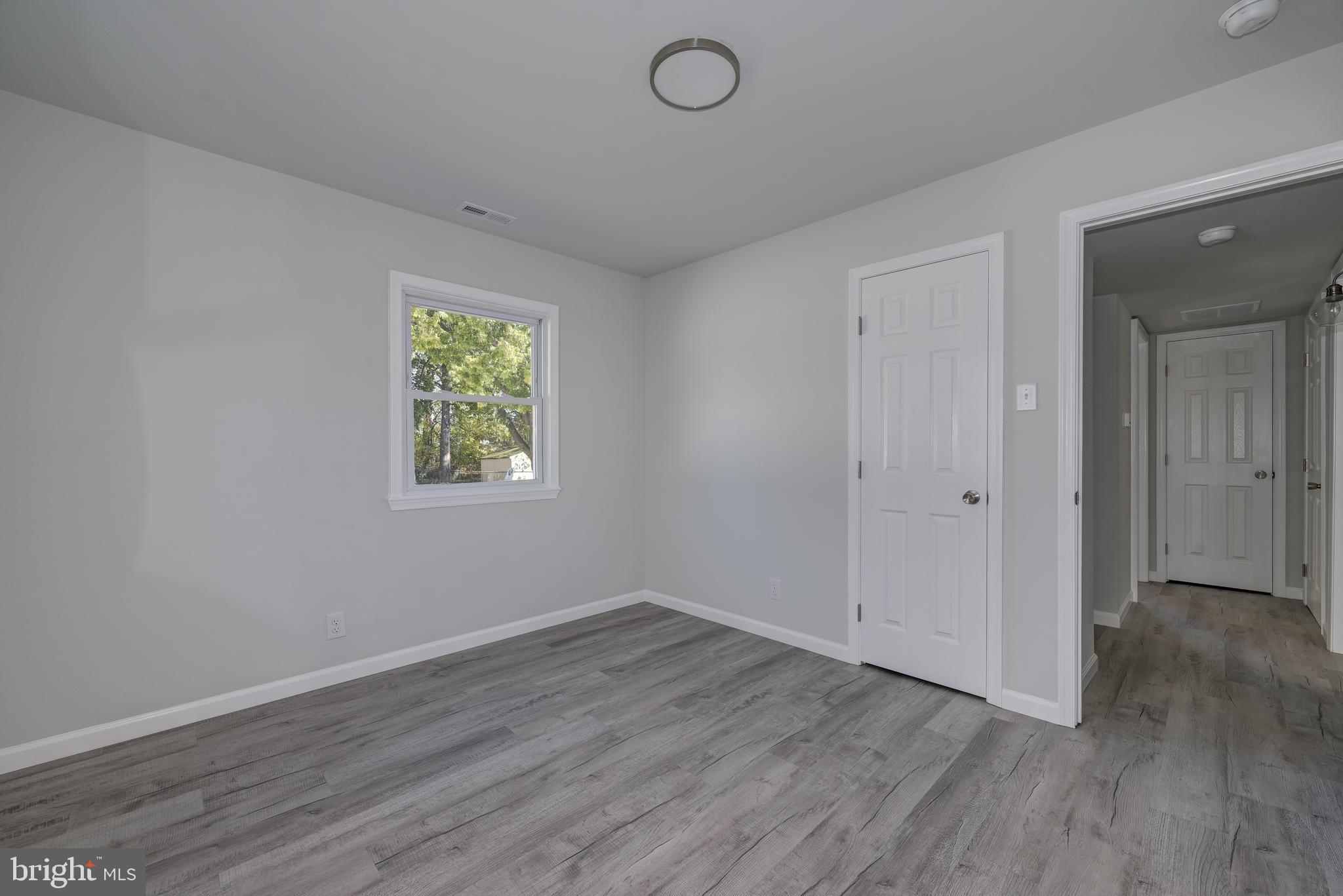 477 Buttonwood Avenue Maple Shade, NJ 08052 - Photo 22 of 32 an empty room with wooden floor and windows