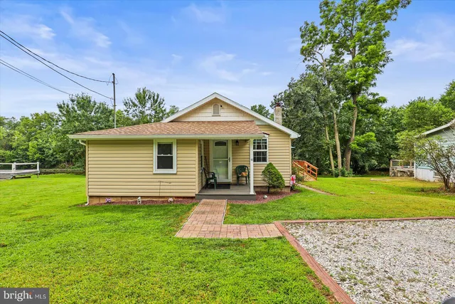a front view of a house with a yard and porch