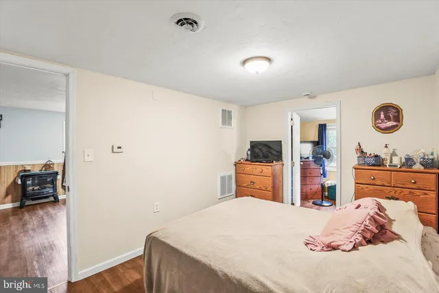 a bedroom with a bed and a dresser