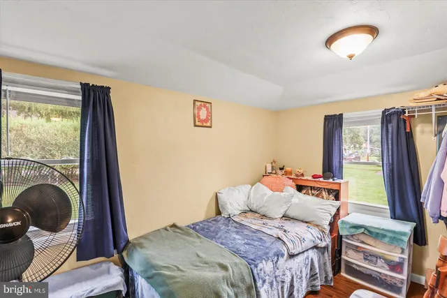 a bedroom with a bed and a large window