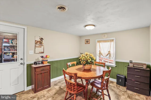 a view of a dining room with furniture and window