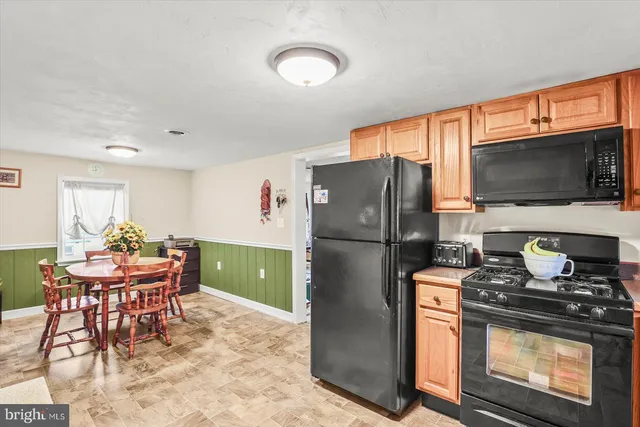 a kitchen with stainless steel appliances granite countertop a refrigerator stove and microwave