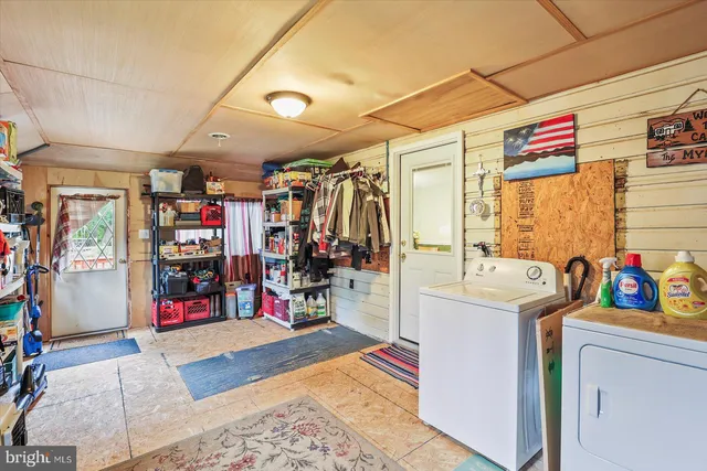 a room with lots of books and a large window