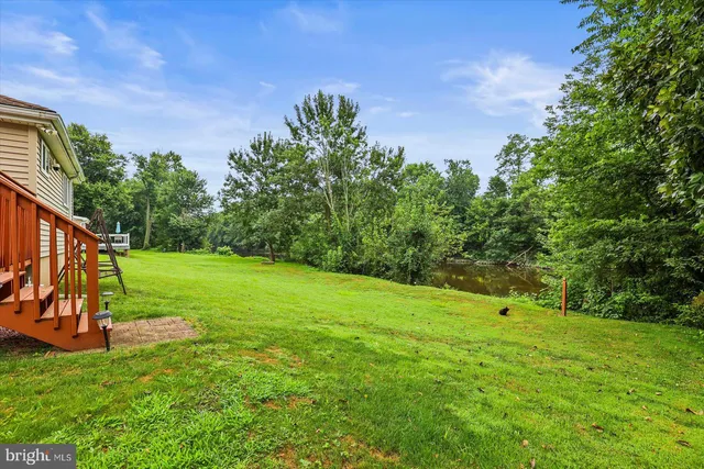 a view of a house with a yard and sitting area