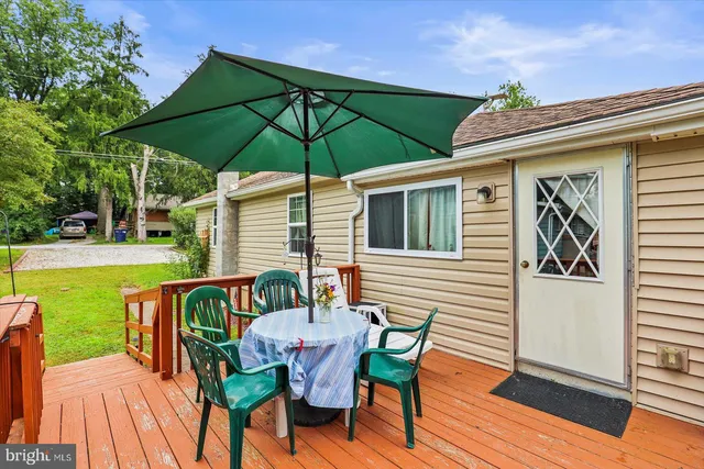 a view of a house with a yard and potted plants