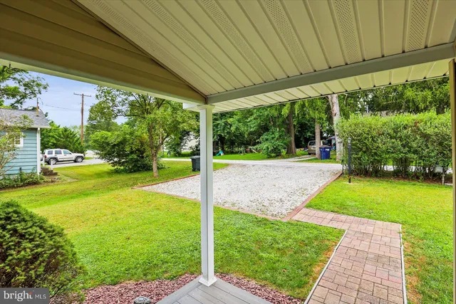 a view of a house with backyard porch and sitting area