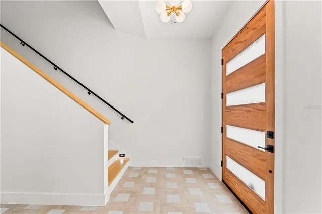 a living room with fireplace furniture and a large window