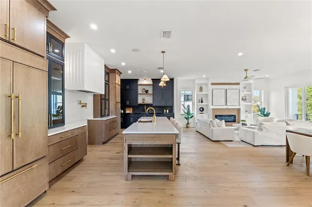 a kitchen with a table chairs sink and cabinets