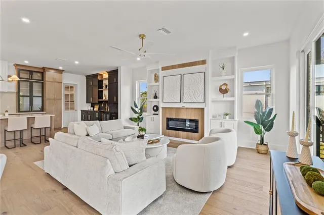a living room with furniture a rug and a chandelier