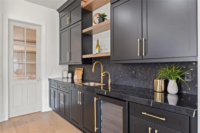 an empty room with windows and ceiling fan