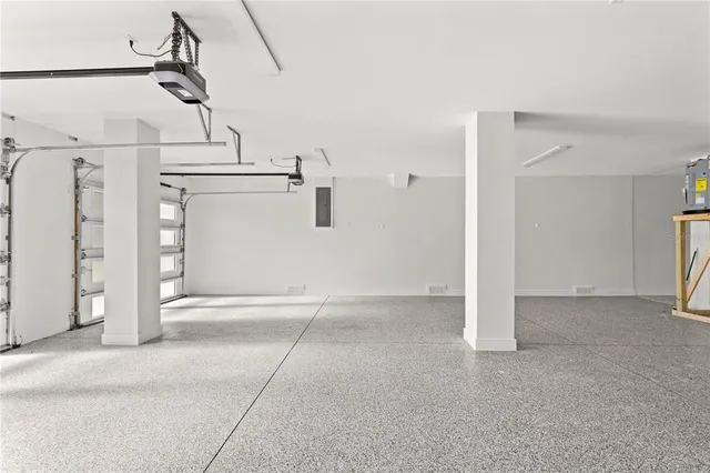 a large living room with stainless steel appliances kitchen island granite countertop furniture and a fireplace