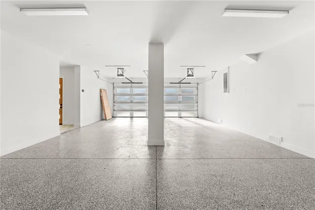 a large kitchen with kitchen island a island a stove a counter top space a sink cabinets and wooden floor