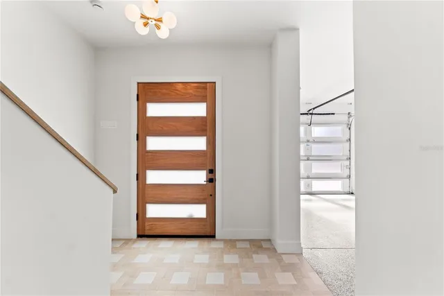 a kitchen with a sink dishwasher a dining table and chairs with wooden floor