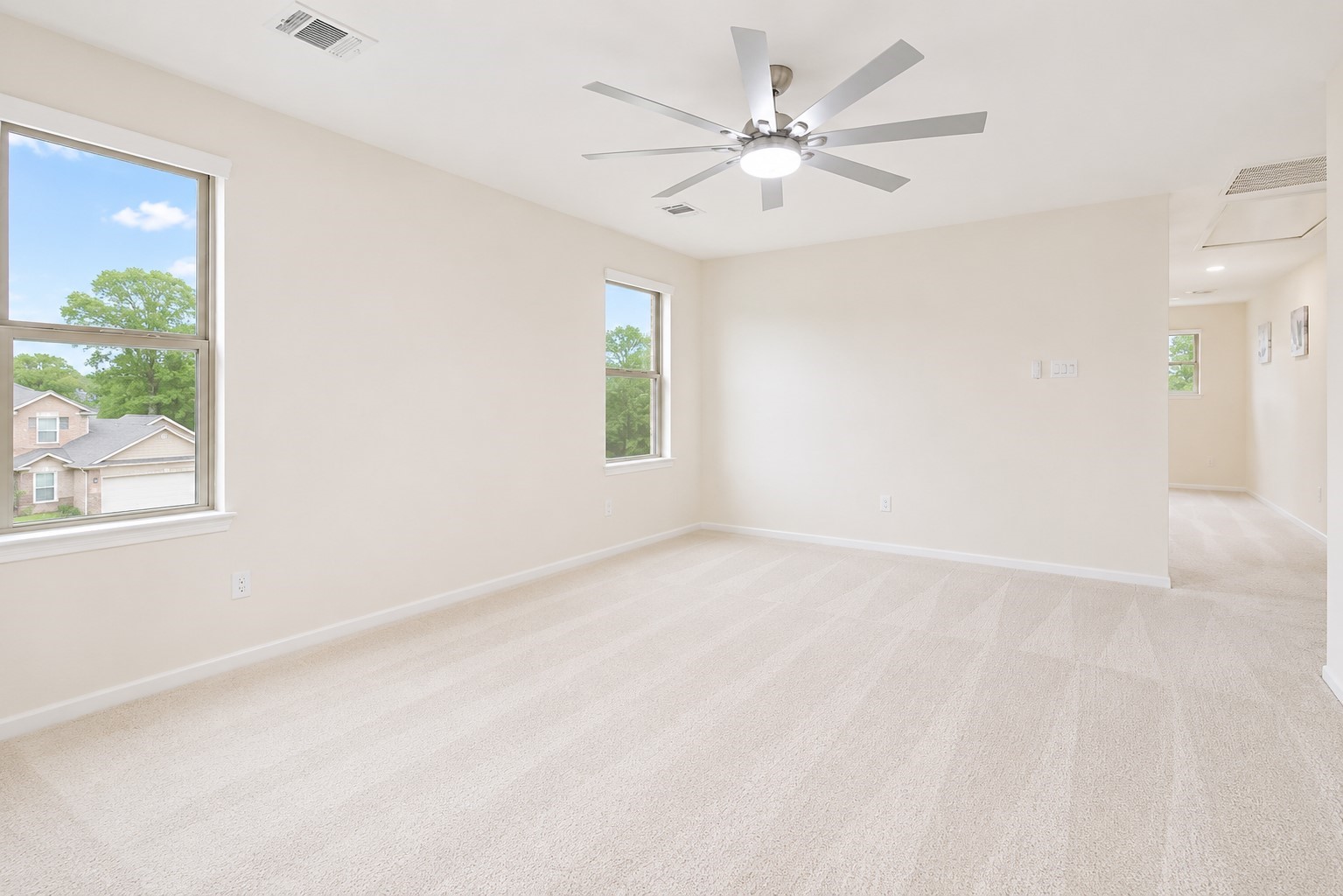 5612 Rainflower Terrace Lane Spring, TX 77389 - Photo 32 of 50 an empty room with windows and fan