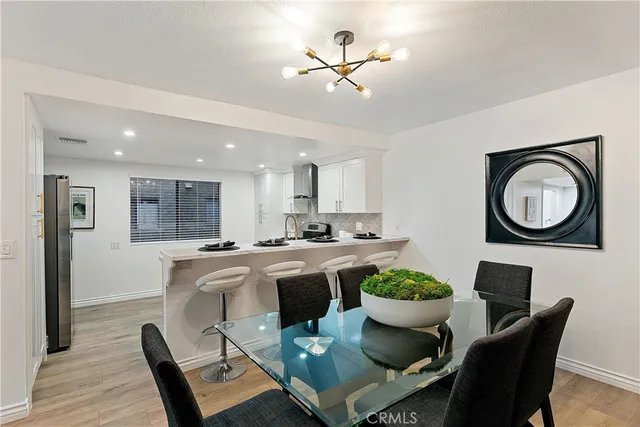a kitchen with a dining table and chairs