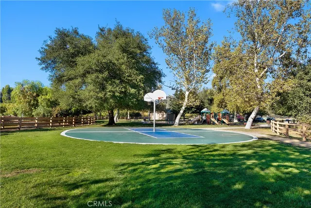 a view of a playground with basketball court
