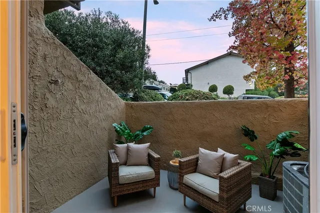 a view of patio with couches and a potted plant