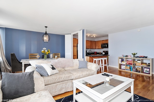 655 West Irving Park Road, Unit 3506 Chicago, IL 60613 - Photo 5 of 9 a living room with furniture and kitchen view
