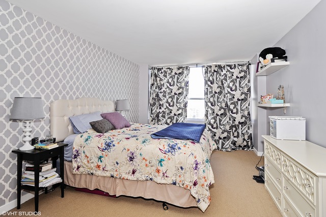 655 West Irving Park Road, Unit 3506 Chicago, IL 60613 - Photo 7 of 9 a bedroom with a bed and a table