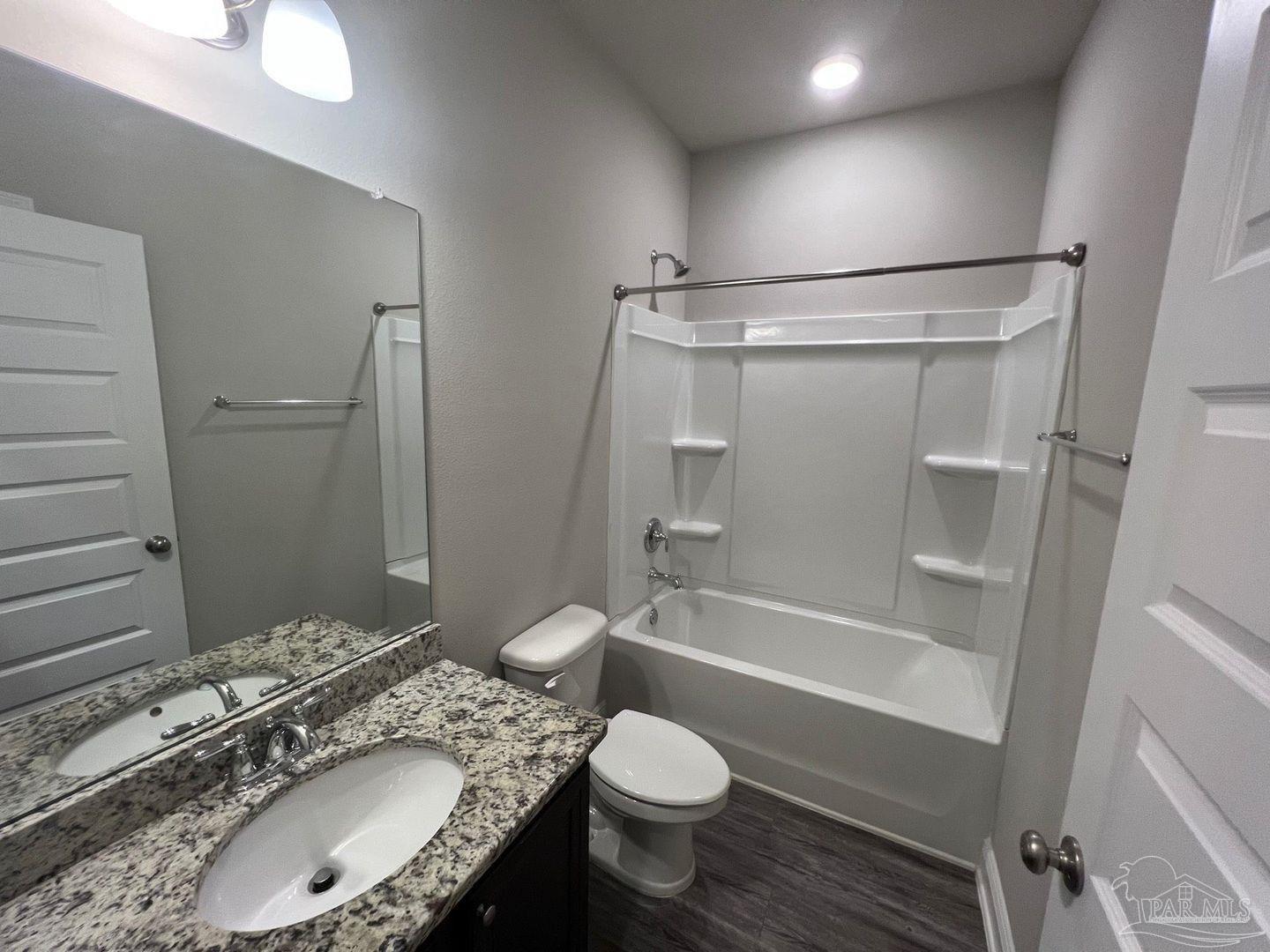 5319 Red Shoulder Road Pace, FL 32571 - Photo 13 of 26 a bathroom with a granite countertop toilet sink and shower