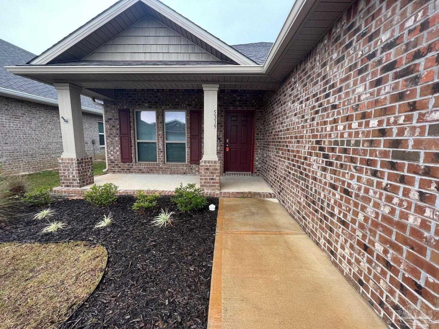 5319 Red Shoulder Road Pace, FL 32571 - Photo 2 of 26 a front view of a house with a garden