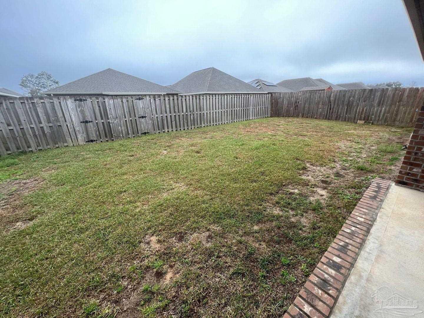 5319 Red Shoulder Road Pace, FL 32571 - Photo 25 of 26 a view of a backyard with a garden