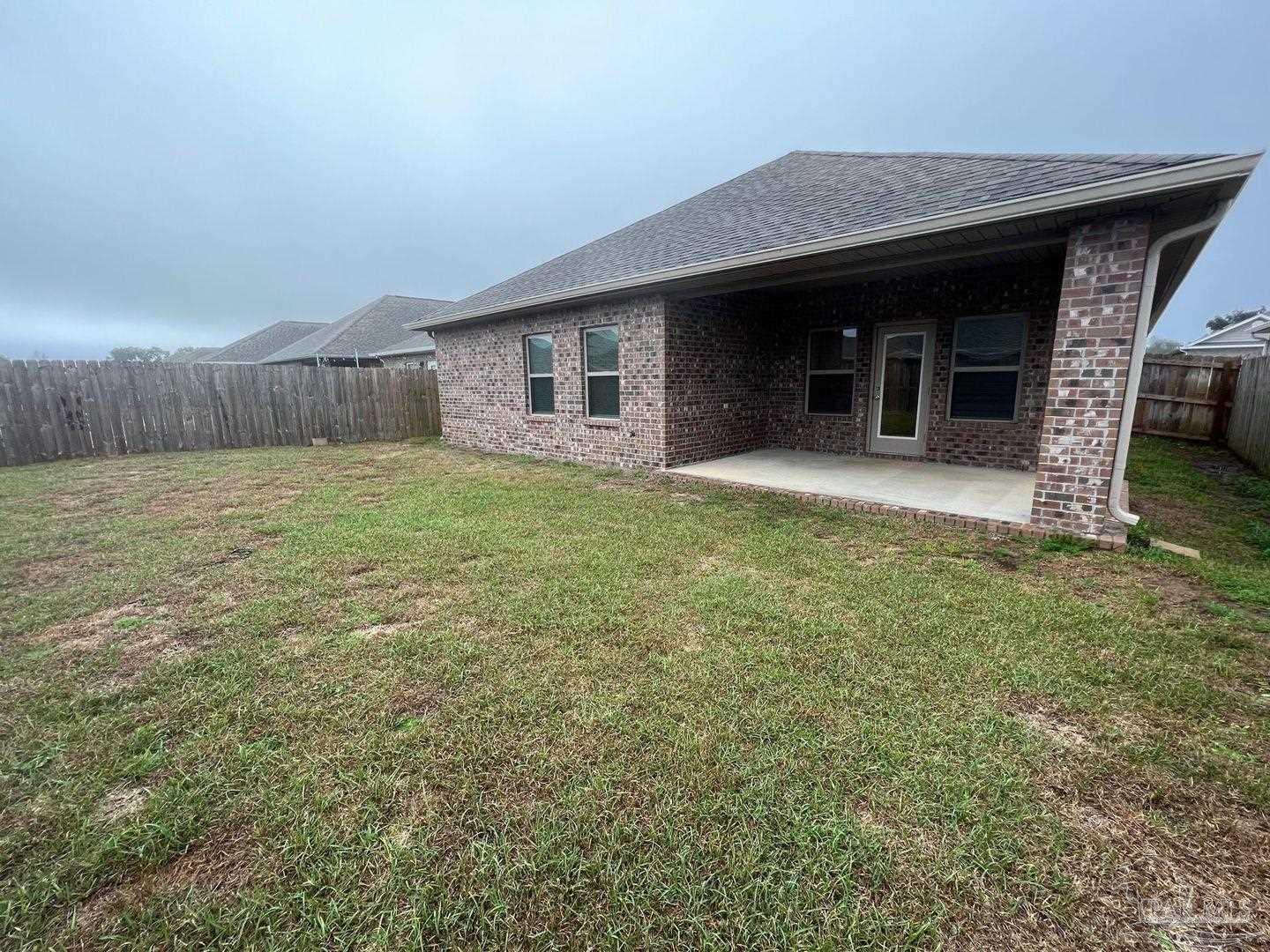 5319 Red Shoulder Road Pace, FL 32571 - Photo 26 of 26 a view of a house with backyard and porch