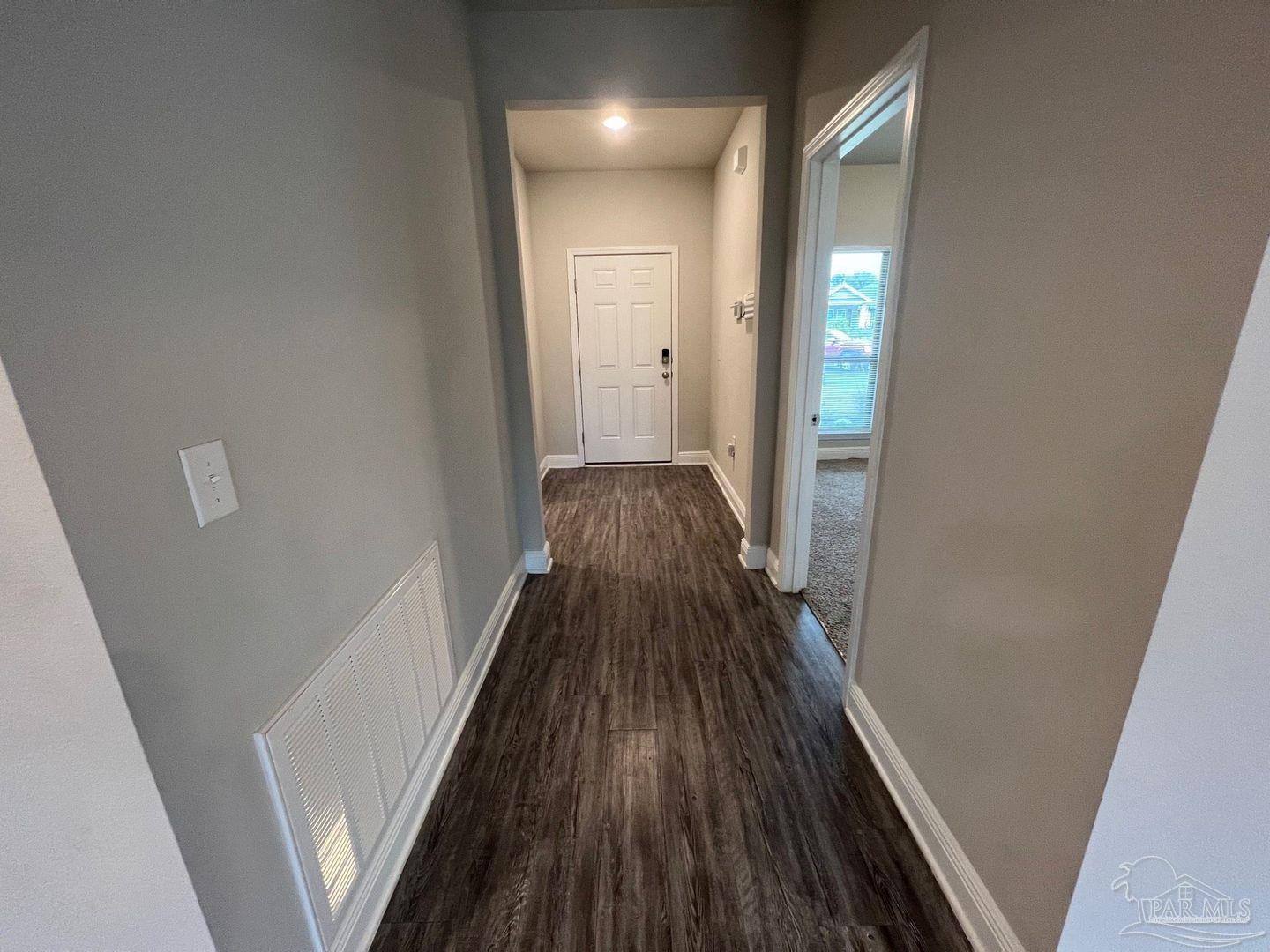 5319 Red Shoulder Road Pace, FL 32571 - Photo 4 of 26 a view of a hallway with wooden floor and staircase