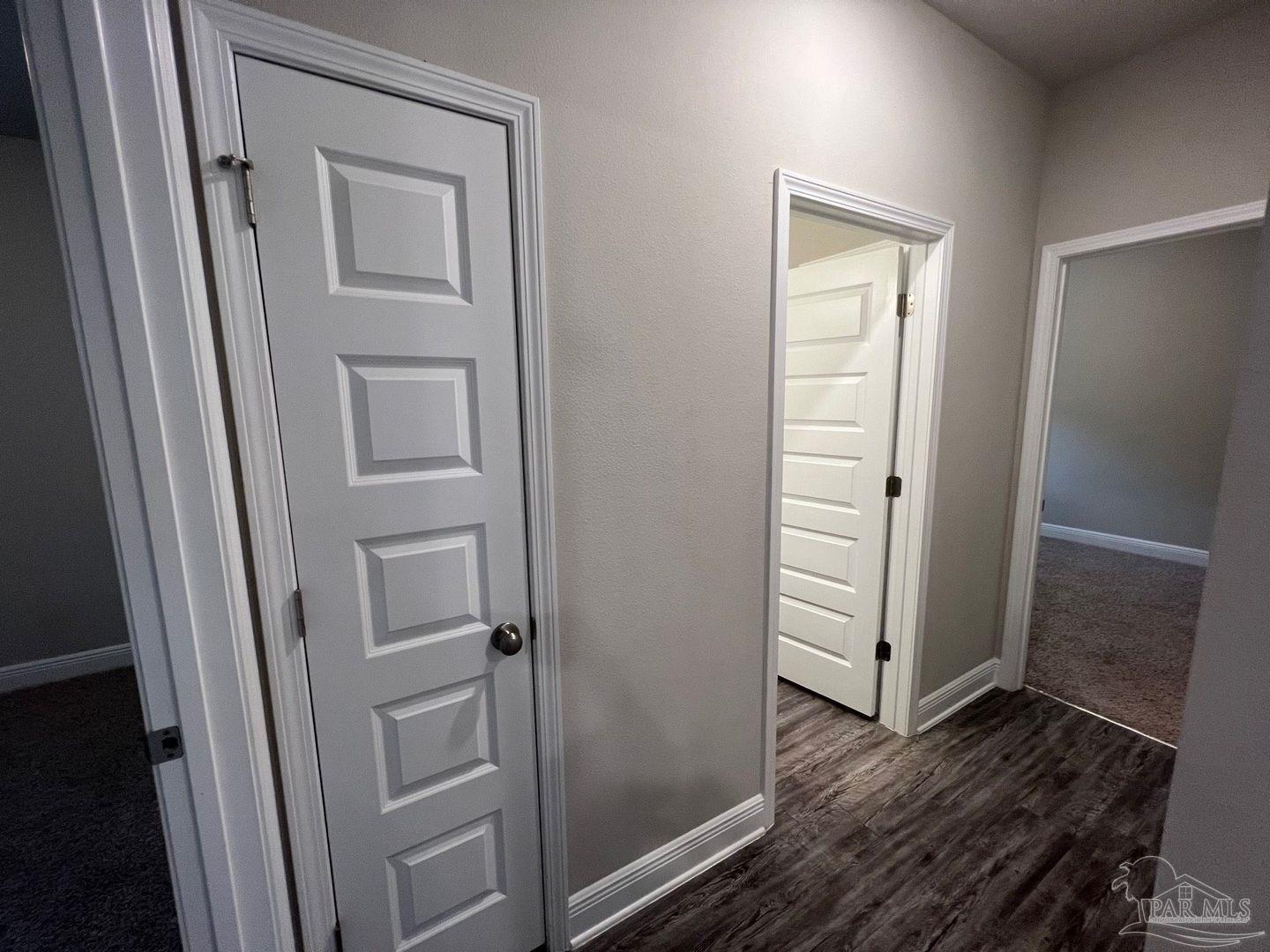 5319 Red Shoulder Road Pace, FL 32571 - Photo 10 of 26 a view of a hallway with wooden floor and closet area
