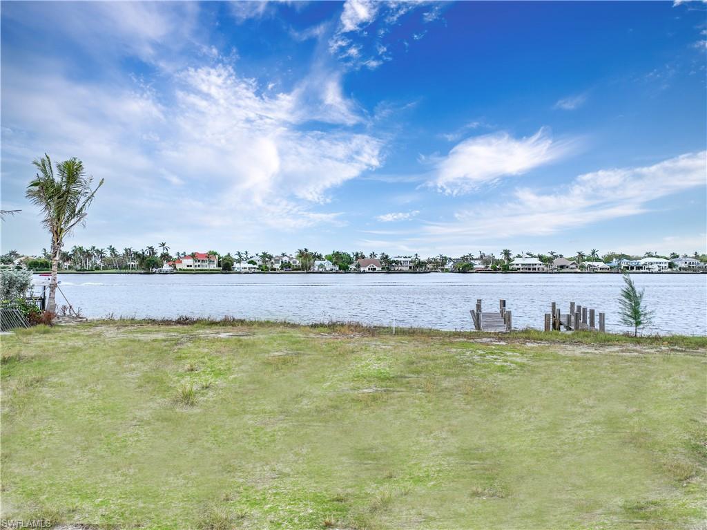 2188 Kingfish Road Naples, FL 34102 - Photo 5 of 14 a view of a swimming pool and a yard