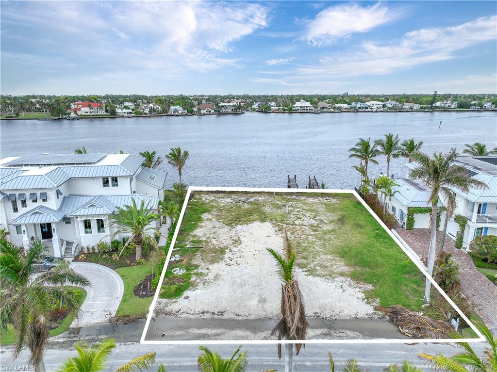 2188 Kingfish Road Naples, FL 34102 - Photo 6 of 14 a view of a lake with a mountain in the background
