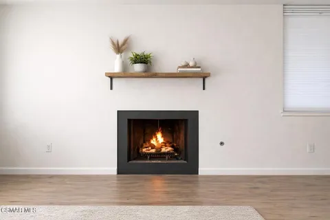 a view of a fireplace with wooden floor