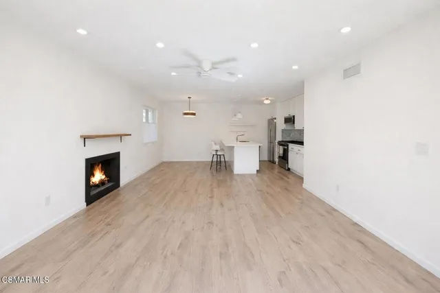 a view of a kitchen with a sink and a fireplace