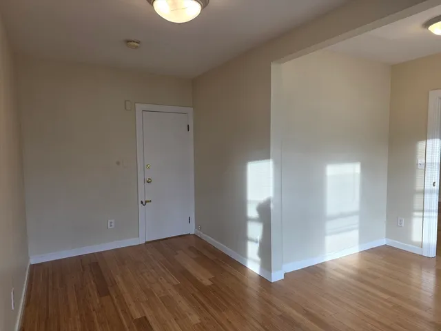 a view of a room with wooden floor