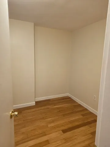 an empty room with wooden floor