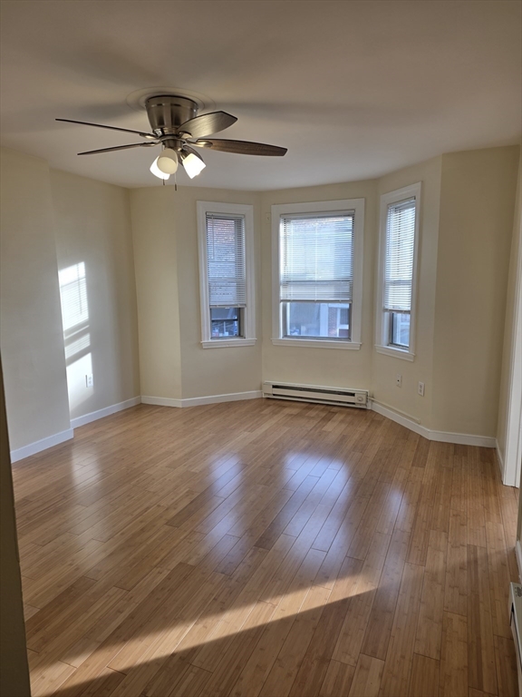 531 Cambridge Street, Unit 2 Cambridge, MA 02141 - Photo 2 of 22 a view of a livingroom with wooden floor and a ceiling fan