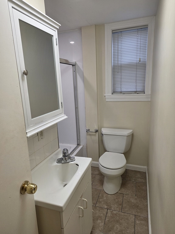 531 Cambridge Street, Unit 2 Cambridge, MA 02141 - Photo 22 of 22 a bathroom with a toilet sink and mirror
