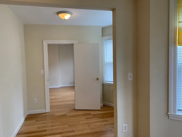 a view of a room with wooden floor