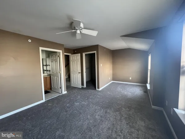 a view of a livingroom with an empty space and a ceiling fan