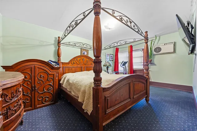 a bed sitting in a bedroom next to a window