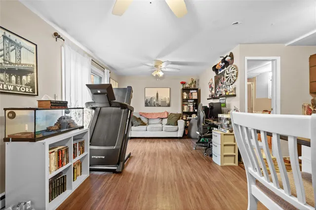 a view of a workspace with furniture and wooden floor